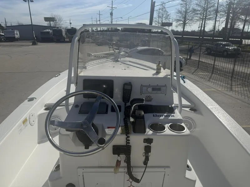 Slide: The Image of Center console of a 2013 BlackJack 224 boat with steering wheel and controls. - 7
