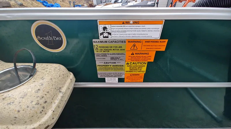 Slide: The Image of ```markdown
South Bay 722CR 2012 boat warning labels and capacity information.
``` - 5