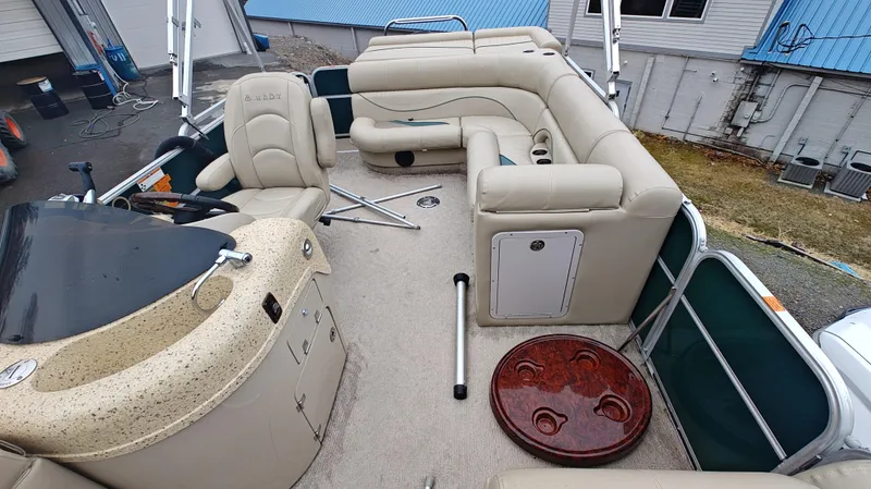 Slide: The Image of 2012 South Bay 722CR pontoon boat interior with beige seating and helm station. - 9