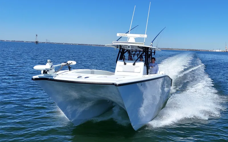 Slide: The Image of 2022 Freeman 34VH boat cruising on open water under clear blue sky. - 10