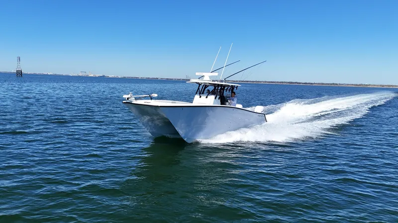 Slide: The Image of Freeman 34VH 2022 boat cruising on open water under clear blue sky. - 11