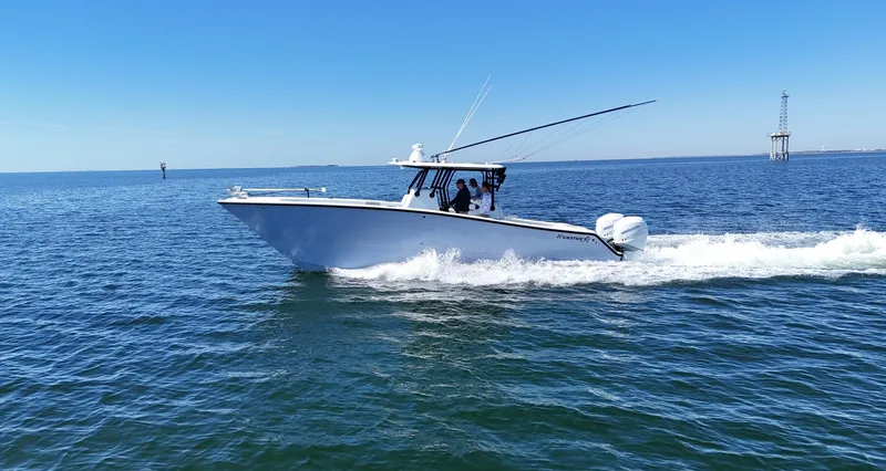 Slide: The Image of 2022 Freeman 34VH boat cruising on open water under clear blue sky. - 12