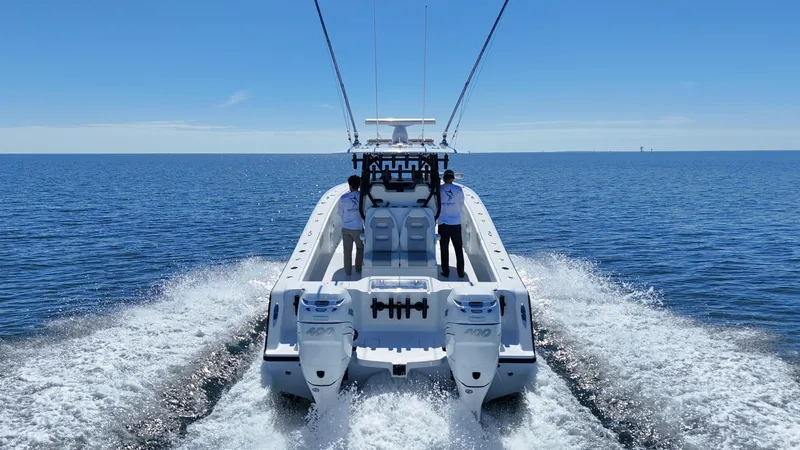 Slide: The Image of 2022 Freeman 34VH boat cruising on open water, rear view. - 15