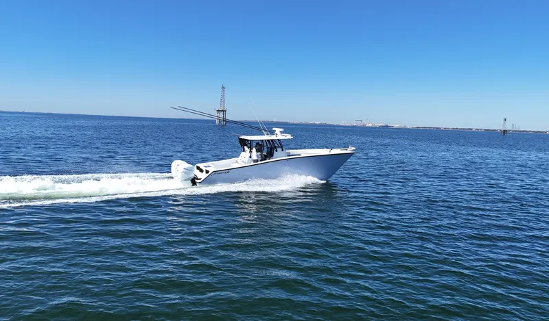 Slide: The Image of Freeman 34VH 2022 boat cruising on open water under clear blue sky. - 16