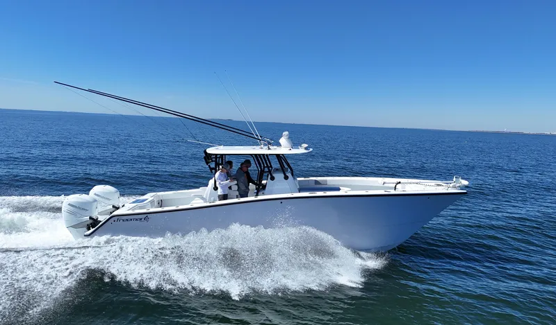 Slide: The Image of 2022 Freeman 34VH boat cruising on open water under clear blue sky. - 17