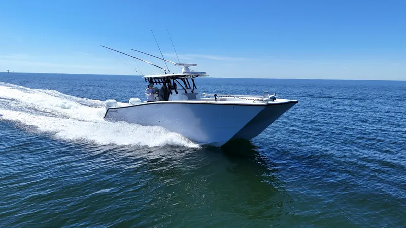 Slide: The Image of 2022 Freeman 34VH boat cruising on open water under clear blue sky. - 19