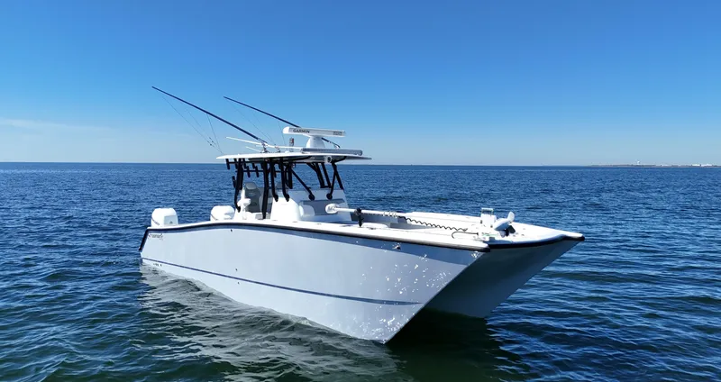 Slide: The Image of 2022 Freeman 34VH boat on open water under clear blue sky. - 2