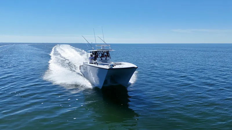 Slide: The Image of Freeman 34VH 2022 boat cruising on open water under clear blue sky. - 20