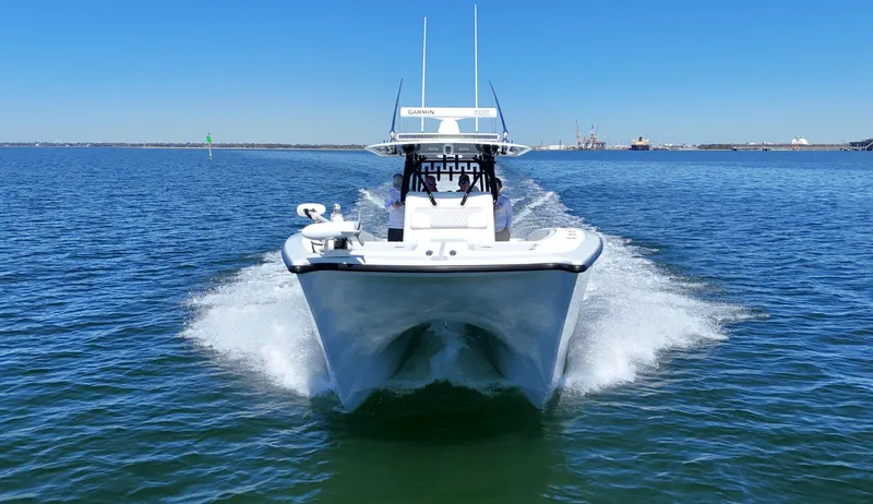 Slide: The Image of Freeman 34VH 2022 boat cruising on open water under clear blue sky. - 21