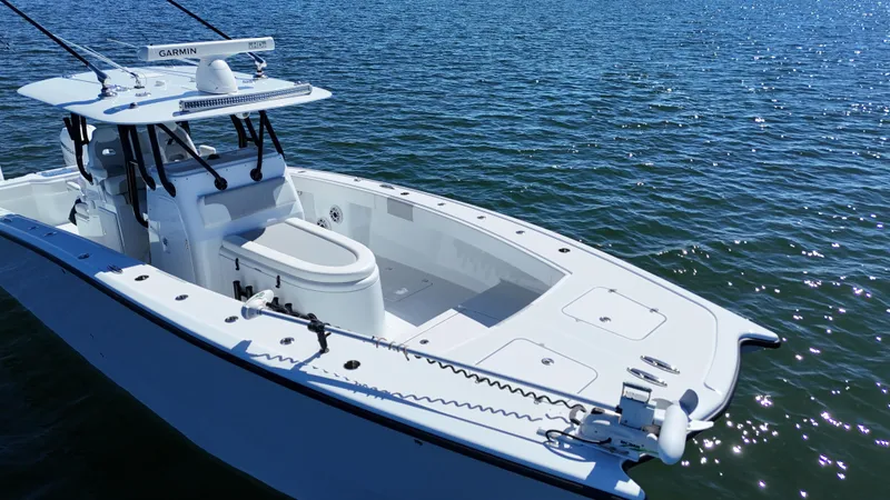 Slide: The Image of 2022 Freeman 34VH boat on calm water, showcasing sleek design and advanced features. - 23