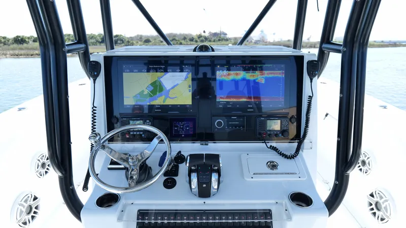 Slide: The Image of Freeman 34VH 2022 boat dashboard with navigation screens and steering wheel. - 28