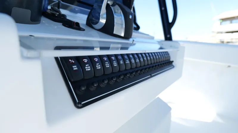 Slide: The Image of Control panel of a 2022 Freeman 34VH boat, featuring multiple switches and buttons. - 30