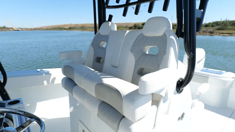 Slide: The Image of Luxury seating on a 2022 Freeman 34VH boat, overlooking serene water. - 34