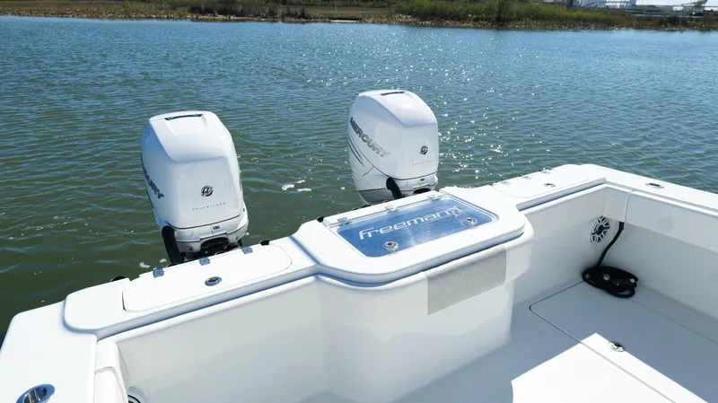 Slide: The Image of Freeman 34VH 2022 boat with dual Mercury outboard engines on a calm lake. - 35