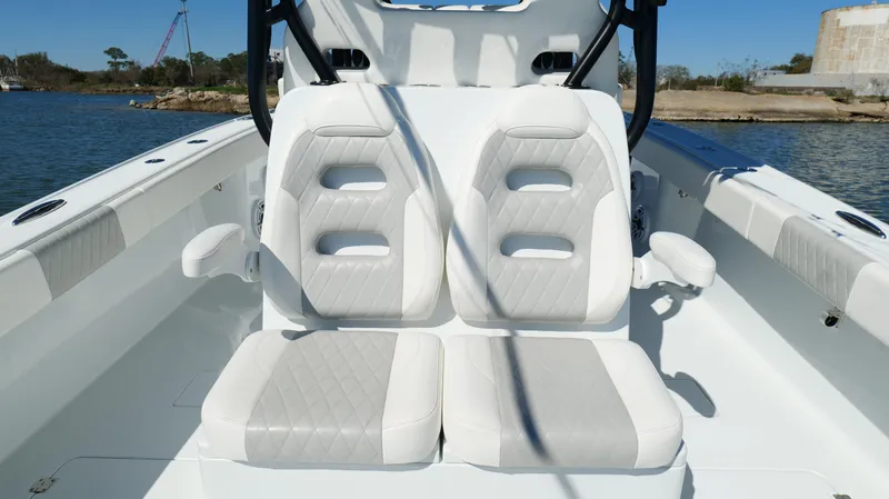 Slide: The Image of 2022 Freeman 34VH boat interior with dual cushioned seats on a sunny day. - 39