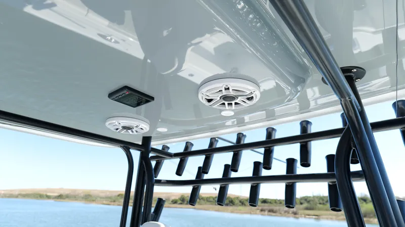 Slide: The Image of Freeman 34VH 2022 boat roof with speakers and rod holders, overlooking water. - 43