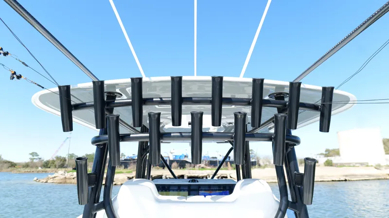 Slide: The Image of 2022 Freeman 34VH boat with multiple rod holders, viewed from the rear on a sunny day. - 44