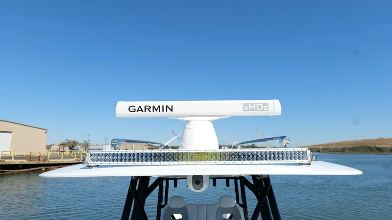 Slide: The Image of Freeman 34VH 2022 boat with Garmin radar on calm water under clear blue sky. - 46