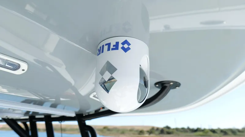 Slide: The Image of FLIR camera mounted on Freeman 34VH boat, 2022 model, under clear sky. - 49