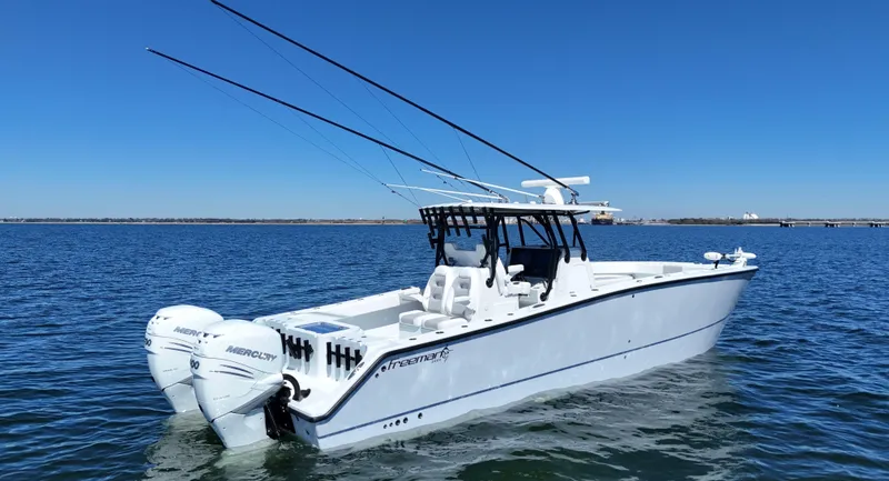 Slide: The Image of 2022 Freeman 34VH boat on open water with dual outboard motors. - 9