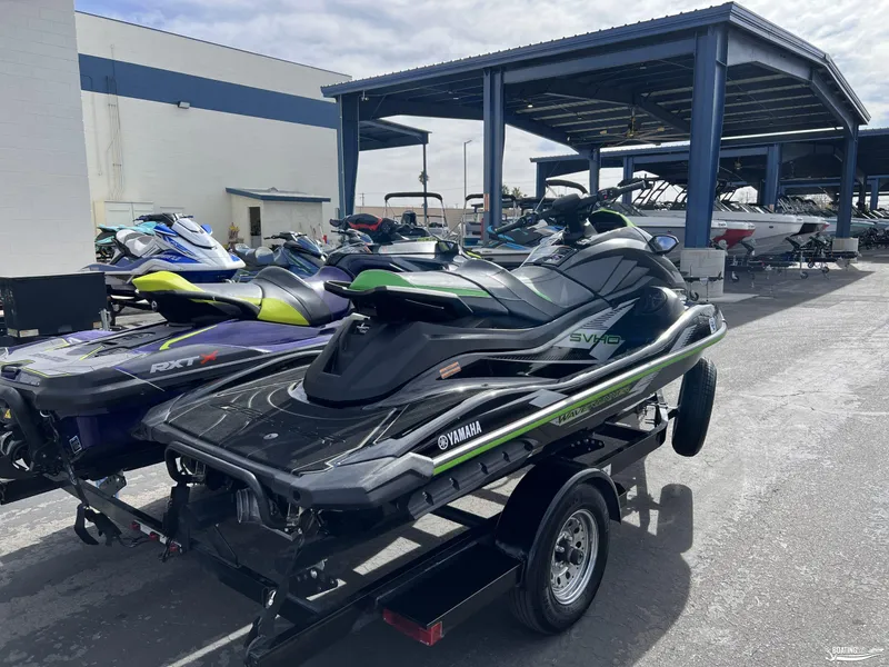Slide: The Image of 2021 Yamaha WaveRunner GP1800R and Sea Doo RTX300 jet skis on trailer at marina. - 3