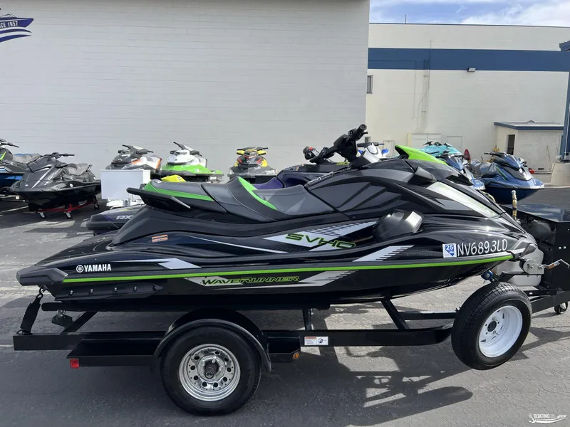 Slide: The Image of 2021 Yamaha WaveRunner GP1800R on trailer, parked outdoors with other jet skis. - 4