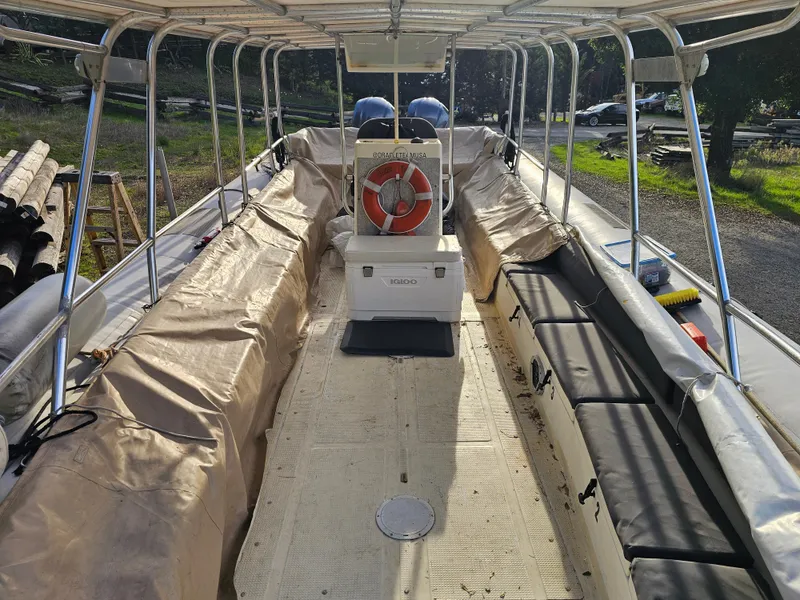 Slide: The Image of 1996 Eduardono RIB boat interior with canopy and seating, featuring a life preserver. - 11