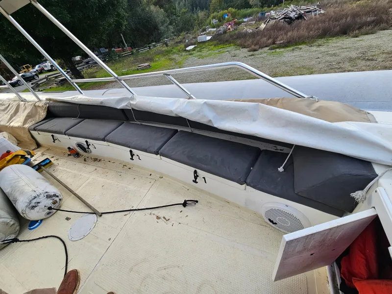 Slide: The Image of 1996 Eduardono RIB boat interior with cushioned seating and open storage compartments. - 12