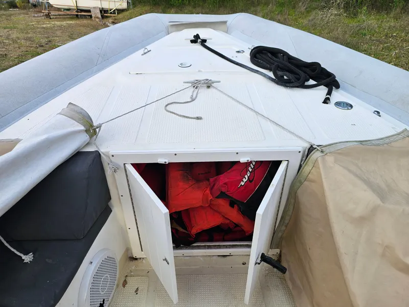 Slide: The Image of 1996 Eduardono RIB boat with open storage compartment containing life jackets. - 9