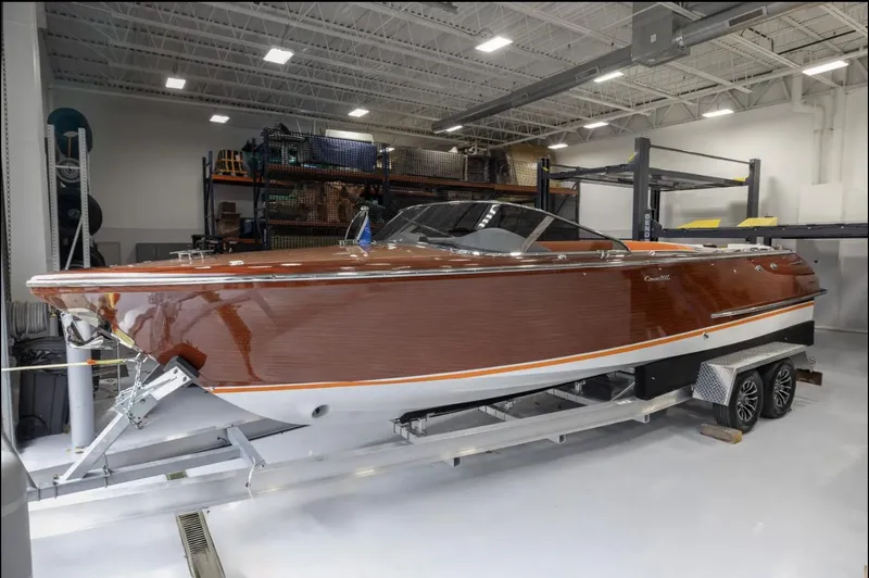 The Image of 2025 Comitti Venezia V28 luxury boat in a showroom, showcasing sleek design and craftsmanship. - 0