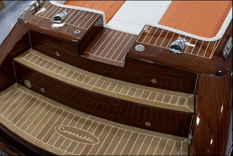 Slide: The Image of 2025 Comitti Venezia V28 boat with elegant wooden deck and steps. - 12