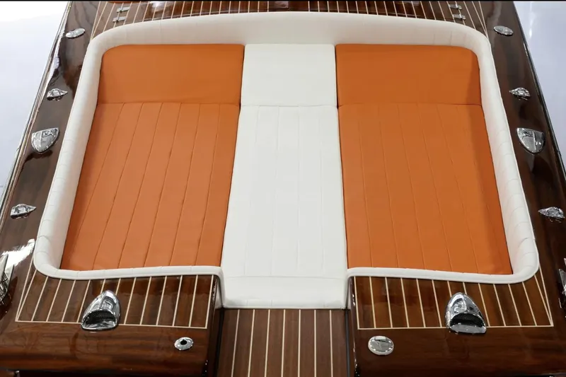 Slide: The Image of 2025 Comitti Venezia V28 boat with orange and white cushioned seating. - 13