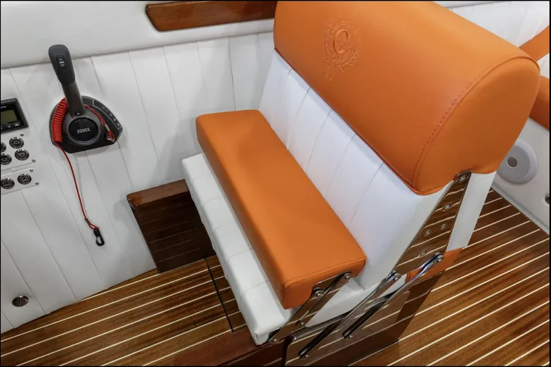 Slide: The Image of 2025 Comitti Venezia V28 interior with orange and white seating, wooden flooring, and control panel. - 17
