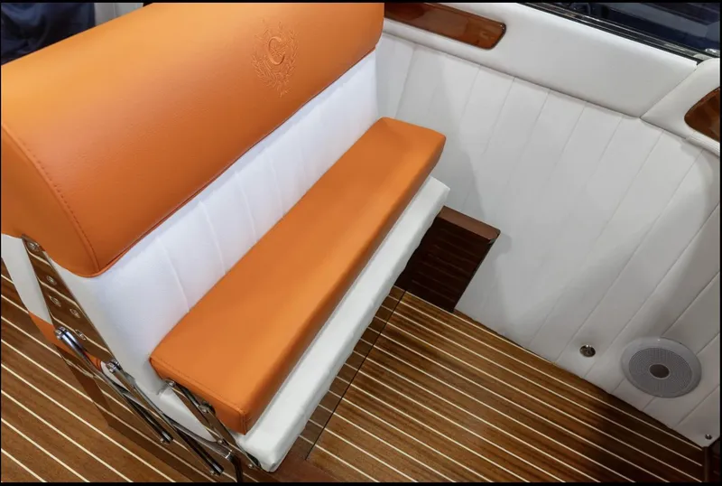 Slide: The Image of 2025 Comitti Venezia V28 interior with orange and white seating, wooden flooring. - 18