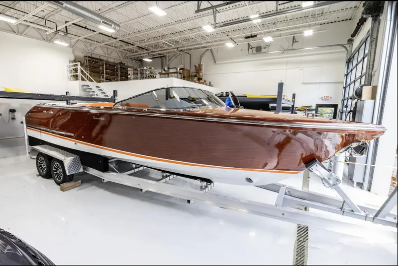 Slide: The Image of 2025 Comitti Venezia V28 boat in a showroom, showcasing sleek design and polished finish. - 3