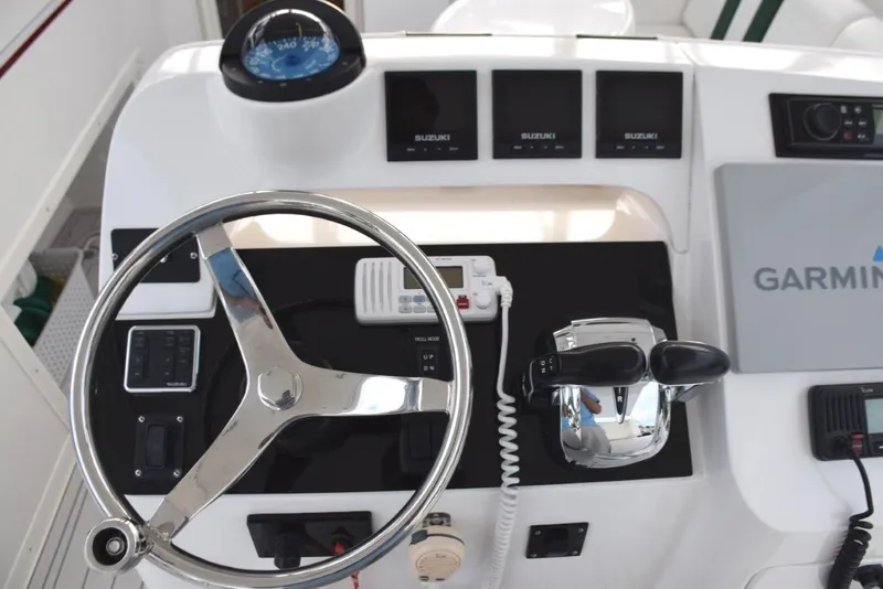 Slide: The Image of Two Icom Vhfs, Garmin, Fusion, triple Suzuki digital displays - 9