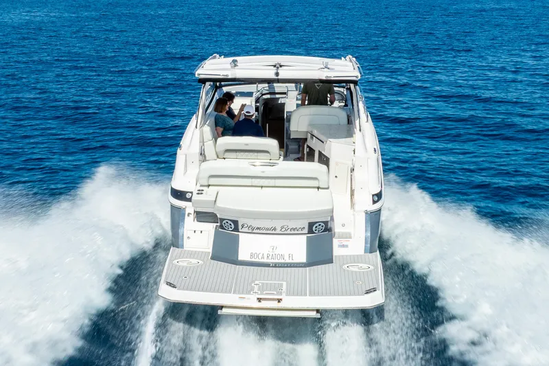 Slide: The Image of 2020 Regal 35 Sport Coupe cruising on open blue water, rear view. - 10
