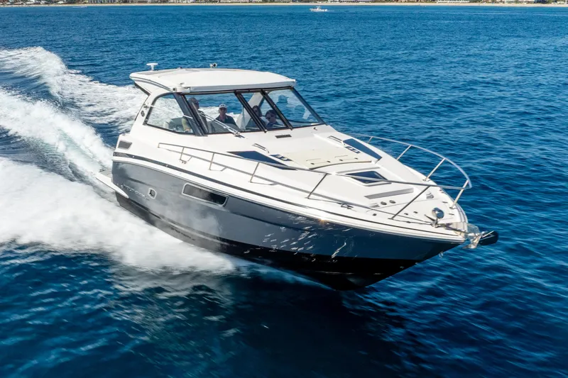 Slide: The Image of 2020 Regal 35 Sport Coupe cruising on open blue water. - 13