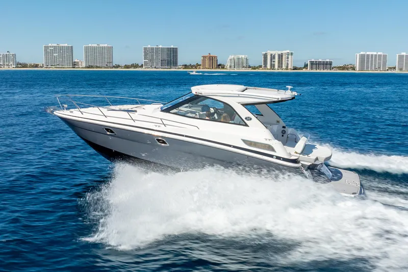 Slide: The Image of 2020 Regal 35 Sport Coupe cruising on blue ocean with city skyline backdrop. - 14
