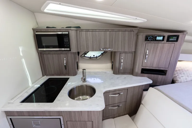 Slide: The Image of 2020 Regal 35 Sport Coupe interior kitchen with modern appliances and sleek cabinetry. - 23