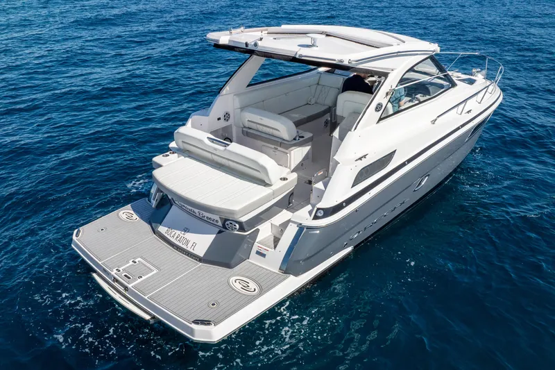 Slide: The Image of 2020 Regal 35 Sport Coupe cruising on clear blue water. - 3