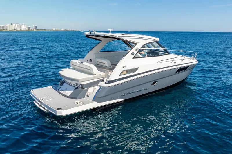 Slide: The Image of 2020 Regal 35 Sport Coupe yacht cruising on open blue water. - 4