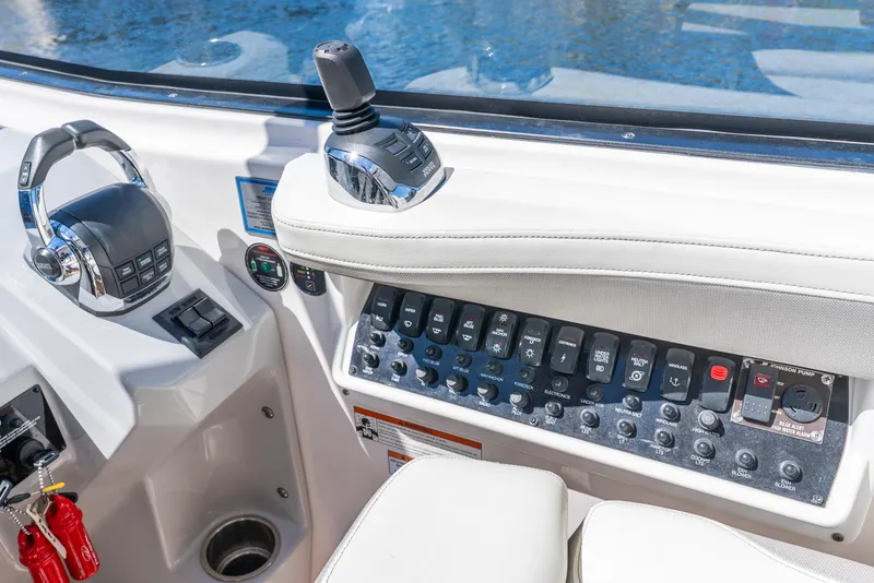 Slide: The Image of Control panel of 2020 Regal 35 Sport Coupe boat with joystick and switches. - 42