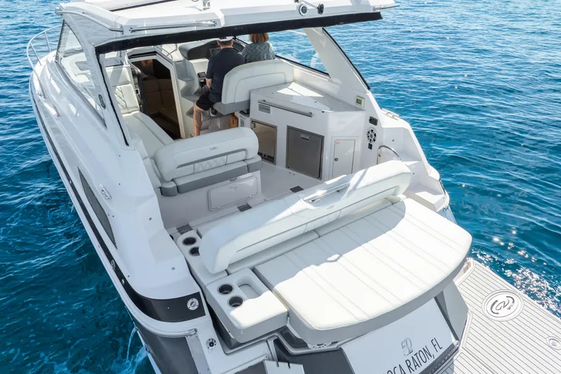 Slide: The Image of 2020 Regal 35 Sport Coupe yacht on clear blue water, rear view. - 8