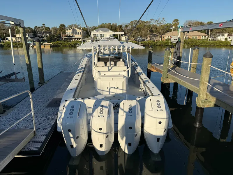 Slide: The Image of 2025 Yellowfin 42 CC boat docked with four powerful outboard engines. - 10