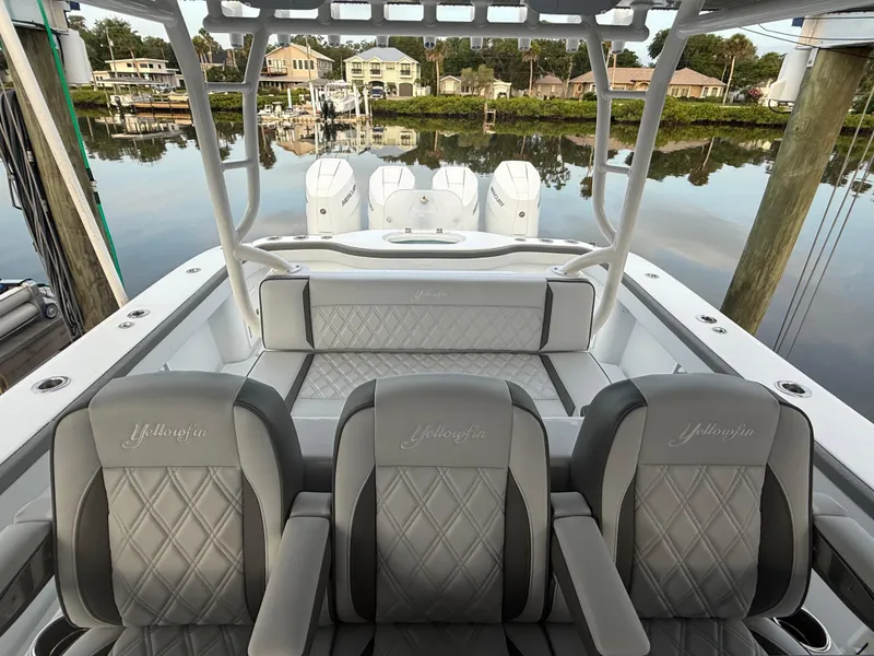 Slide: The Image of 2025 Yellowfin 42 CC boat interior with luxurious seating and waterfront view. - 11