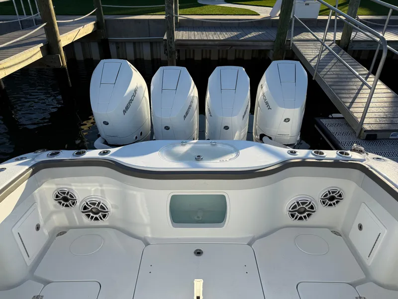 Slide: The Image of 2025 Yellowfin 42 CC boat with four powerful outboard engines docked at a marina. - 12
