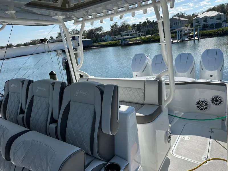 Slide: The Image of 2025 Yellowfin 42 CC boat interior with luxurious seating and powerful engines. - 14