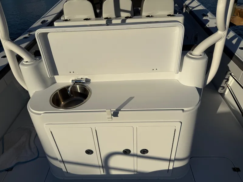Slide: The Image of 2025 Yellowfin 42 CC boat interior with sink and storage compartments. - 21