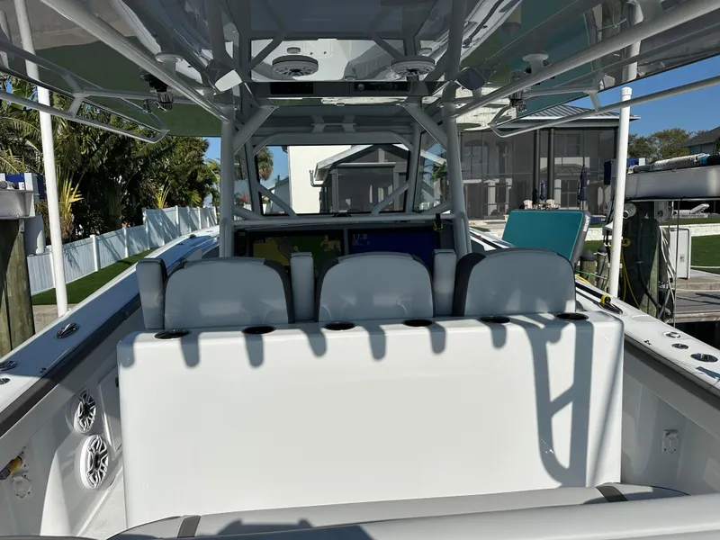 Slide: The Image of 2025 Yellowfin 42 CC boat interior with seating and console, docked outdoors. - 27